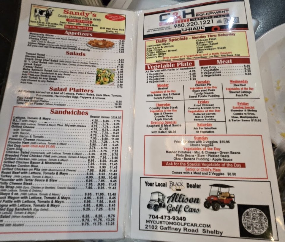 Menu board featuring appetizers and fresh salads.
